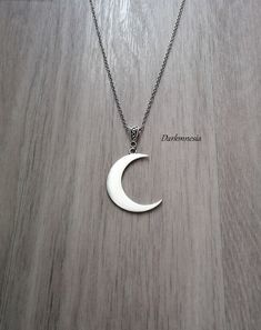 Vrescent moon necklace. Dimensions: Chain: 52 centimeters Moon: 4.3 centimeters high and 3.3 centimeters wide The length can be adjusted on request at the time of purchase, at no additional cost. Materials used: stainless steel chain and zinc alloy pendant. This jewel will be delivered to you in a small organza pouch and sent by registered letter for better reception. To keep your jewelry in perfect condition, store them away from humidity and sunlight and avoid contact with water and perfume. J Gothic Necklaces With Moon Charm Pendant, Gothic Moon Charm Pendant Necklaces, Gothic Moon Charm Pendant Necklace, Gothic Pendant Necklaces With Moon Charm, Gothic Necklace With Moon Charm For Gifts, Gothic Moon Charm Necklace As Gift, Gothic Moon Charm Necklace For Gift, Gothic Style Moon Charm Necklace Gift, Gothic Sterling Silver Necklaces With Moon Phase