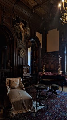 an old fashioned living room with ornate wood paneling and chandelier above the couch