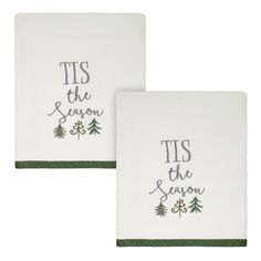 two white towels with green trimmings and the words tis the season on them