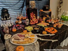 a table topped with lots of halloween food