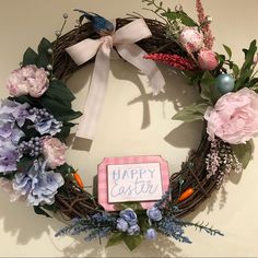 a happy easter wreath with pink and blue flowers