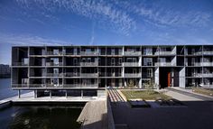 an apartment building next to the water