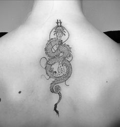 a woman with a dragon tattoo on her back