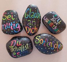 four painted rocks with words on them