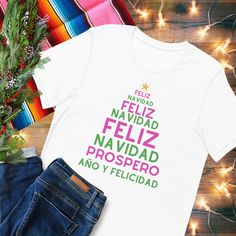 Feliz navidad y prospero año T-Shirt.  This classic unisex jersey short sleeve tee fits like a well-loved favorite. Soft cotton and quality print make users fall in love with it over and over again. These t-shirts have-ribbed knit collars to bolster shaping. The shoulders have taping for better fit over time. Dual side seams hold the garment's shape for longer. Christmas T-shirt With Text Print For Gifting, Christmas Short Sleeve T-shirt With Text Print, Christmas Gift T-shirt With Text Print, Christmas Text Print T-shirt As Gift, Christmas Text Print T-shirt Gift, Christmas Text Print Short Sleeve T-shirt, New Year Gift Crew Neck T-shirt, White Christmas T-shirt With Text Print, New Year Crew Neck T-shirt With Letter Print