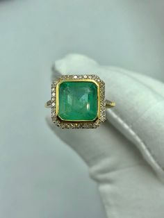 Luxury Emerald Crystal Ring For Anniversary, Luxury Yellow Gold Emerald Ring For Women, 14k Gold Gia Certified Emerald Ring Gift, Gia Certified 14k Gold Emerald Ring Gift, Emerald-cut Yellow Gold Halo Ring For Gift, Emerald Cluster Ring Stamped 14k As Gift, Emerald Cut Yellow Gold Halo Ring Gift, Gia Certified Gold Rings For May Birthstone, Green 14k Gold Halo Ring As A Gift