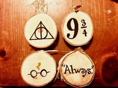 three wooden slices with harry potter symbols on them and the number nine, 994, always