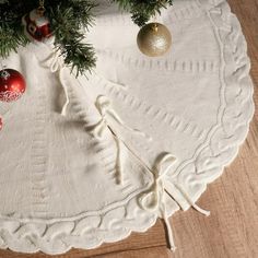 a christmas tree skirt with ornaments on it