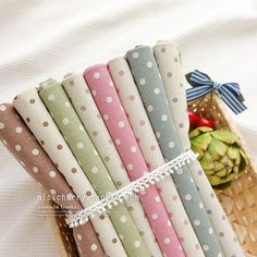 a basket filled with lots of different colored papers