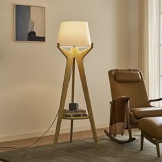 a wooden floor lamp in a living room