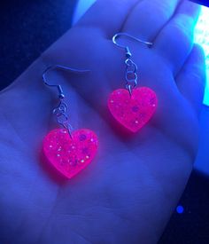 Each pair of sparkly neon pink heart earrings are handmade to order, therefore no two pairs are identical! Every resin jewelry piece in my shop is slightly unique and one of a kind! However, I try to get as close to the listing photos as possible :) Made with nickel-free, hypoallergenic, sterling silver plated fishhooks earrings.  Hearts are approximately 19mm, and are made with epoxy resin and neon pink chunky holographic glitter ✨ UV Blacklight reactive! Perfect for raves, festivals, Valentine Handmade Jewelry For Valentine's Day Party, Nickel-free Pink Heart Cut Jewelry, Pink Heart Cut Earrings For Party, Cute Heart Charm Jewelry For Parties, Cute Party Jewelry With Heart Charm, Heart Shaped Pierced Jewelry For Party, Cute Heart Charm Party Jewelry, Heart Shaped Pierced Party Jewelry, Cute Party Earrings With Heart Charm