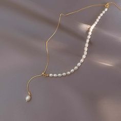 ✦ Enhance her elegance with our Elegant Freshwater Pearl Adjustable Necklace. This exquisite necklace features lustrous freshwater pearls delicately strung on a dainty chain with an adjustable length, allowing her to customize the fit and style. The timeless beauty of the pearls adds a touch of sophistication to any outfit. Gift her this elegant pearl necklace, a symbol of grace and refinement. ----------- DETAILS ------------ SKU: A8432- Materials: Alloy, Brass, Freshwater Pearl- Necklace Length: Adjustable Dainty Adjustable Lariat Necklace With Pearl Chain, Adjustable Dainty Lariat Necklace With Pearl Chain, Pearl Dangle Lariat Necklace, Adjustable Dainty Pearl Necklace, Dainty Adjustable Dangle Pearl Necklace, Dainty Adjustable Drop Necklace With Pearl Pendant, Pearl Lariat Necklace With Adjustable Chain For Gifts, Minimalist Pearl Lariat Necklace As Gift, Dangle Pearl Necklace With Delicate Chain