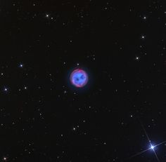 an image of a blue object in the middle of the night sky with stars around it