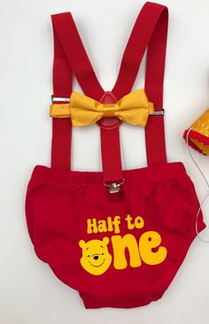 a pair of red suspenders with winnie the pooh on them and a yellow bow tie