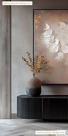 a vase filled with flowers sitting on top of a black table next to a painting