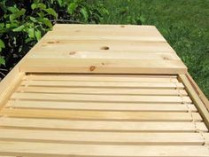 a wooden bench sitting on top of a lush green field