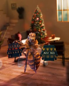 a honeybee holding two pizza boxes in its hands while standing next to a christmas tree