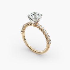 a yellow gold engagement ring with an oval cut diamond in the center and side stones