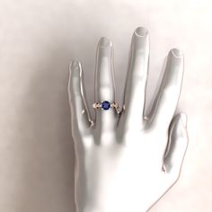 a person's hand with a ring on top of it, against a white background