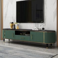 an entertainment center with a large flat screen tv mounted on it's sideboard