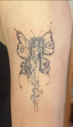 a woman's leg with a tattoo on it that has a butterfly on it