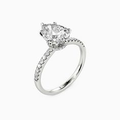 Featuring a row of pavé gems that guide the eyes inwards to the spectacular center stone, this fine engagement ring is designed to highlight the breathtaking brilliance of the pear-cut center stone. With an elegant pear frame secretly appearing underneath the core, this magnificent ring is a paragon of endless love. *Each piece is handmade, resulting in a potential variance of 0.1-0.2mm during measurement. Please refer to the actual item for precise specifications.  Carat Weight: 2 ctStone Size: Pear-shaped Diamond Ring With Pave Setting, Pear-shaped Moissanite Diamond Ring For Proposal, Moissanite Diamond Ring With Vvs Clarity, Pear-shaped, Pear-shaped Diamond Wedding Ring With Prong Setting, Pear-shaped Diamond With Prong Setting For Wedding, Classic Pear-shaped Diamond Ring With Pave Setting, Dazzling Pear-shaped Brilliant Cut Diamond Ring, Elegant Pear-shaped Diamond Ring With Pave Setting, Pear-shaped Moissanite Diamond Ring