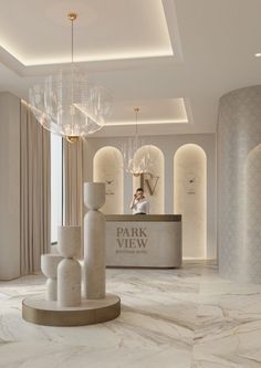 an elegant lobby with chandelier and marble floors, white walls and flooring