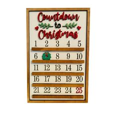 a wooden calendar with numbers on it and the words countdown to christmas written in red