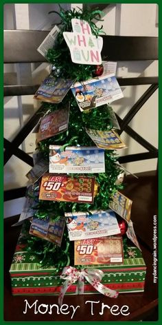 a christmas tree made out of books with money on top and the words, money tree