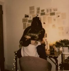 an old photo of two people sitting in a chair with one holding the other's head