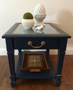 a small table with a vase on top