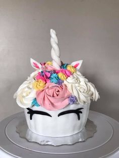 a cake decorated with white frosting and colorful flowers