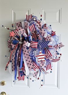 a patriotic wreath hanging on the front door