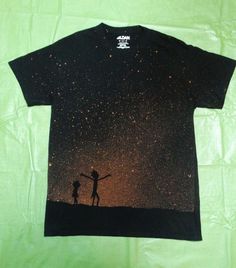 a t - shirt with the silhouette of two people holding hands in front of stars