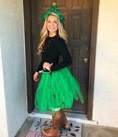 a woman in a green tutu skirt and boots posing for the camera with her hands on her hips