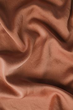 a close up view of an orange colored fabric