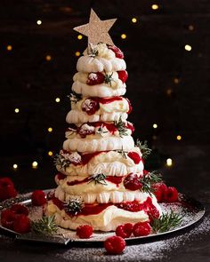 a christmas tree made out of meringue and strawberries on a platter