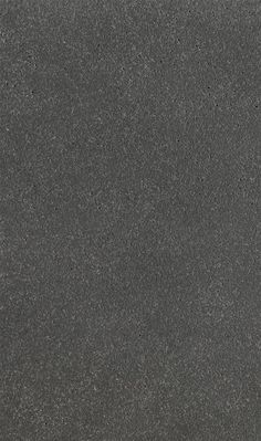 a black and white photo of the surface of a concrete slab, with small speckles