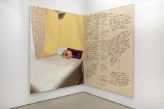 an open book with writing on it and a small child in the bed at the bottom