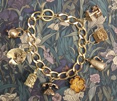 Beautiful thick (10x12mm) brass curb chain bracelet with 8  3D  brass charms. The charms are a mixture of new and vintage (unused) and include a handbag, rose, bird cage with hanging bird (new) and a frog on lilypad, coffee pot, telephone, kettle and carousel (vintage).  The bracelet is a lovely golden colour but as with all brass jewellery it will darken with time but can be repolished or left to form a natural patina as desired. The bracelet will be supplied in a velvet gift pouch. Cheap Vintage Charm Brass Jewelry, Affordable Vintage Charm Brass Jewelry, Affordable Vintage Gold Charm Bracelet, Luxury Vintage Charm Bracelet As A Gift, Luxury Vintage Charm Collectible, Luxury Retro Bracelet As Gift, Cheap Vintage Brass Jewelry With Charm, Cheap Vintage Charm Bracelet As Gift, Cheap Vintage Charm Bracelet Gift