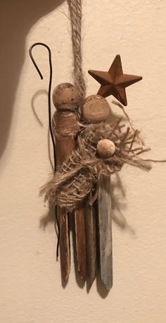 a star is hanging on the wall next to some nails