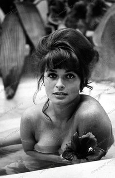 black and white photograph of a woman in a bathtub with flowers on her arm