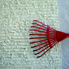 a red comb laying on top of a white towel