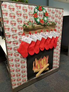 christmas stockings hanging over a fire in an office cubicle decorated for the holiday season