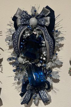 a blue and silver christmas decoration hanging on the wall