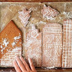 someone is making ginger cookies in the shape of houses