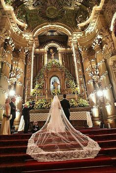 the bride and groom are getting married in front of the alter at their wedding ceremony