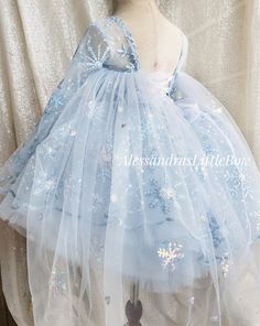 Ice Queen Couture Dress Made with a beautiful sequined snowflake mesh in light blue and irredescent snowflakes, long sheer sleeves, a criss cross back making it super adjustable with voluminous tulle skirt. All dresses are completely lined for comfort. Available in light pink upon request Custom colors and sizes welcomed Handmade to order in the USA Blue Tulle Princess Dress With Long Sleeves, Blue Long Sleeve Tulle Princess Dress, Winter Princess Dress In Tulle For Dress-up, Winter Princess Dress For Dress-up, Winter Tulle Princess Dress For Dress-up, Winter Princess Style Tutu Dress In Tulle, Winter Princess Style Tulle Tutu Dress, Winter Party Dress With Tulle Skirt, Light Blue Long Sleeve Princess Dress For Party