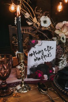 the table is set with flowers, candles and an easel sign that says kadlee i