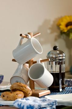 coffee cups and cookies are sitting on a table